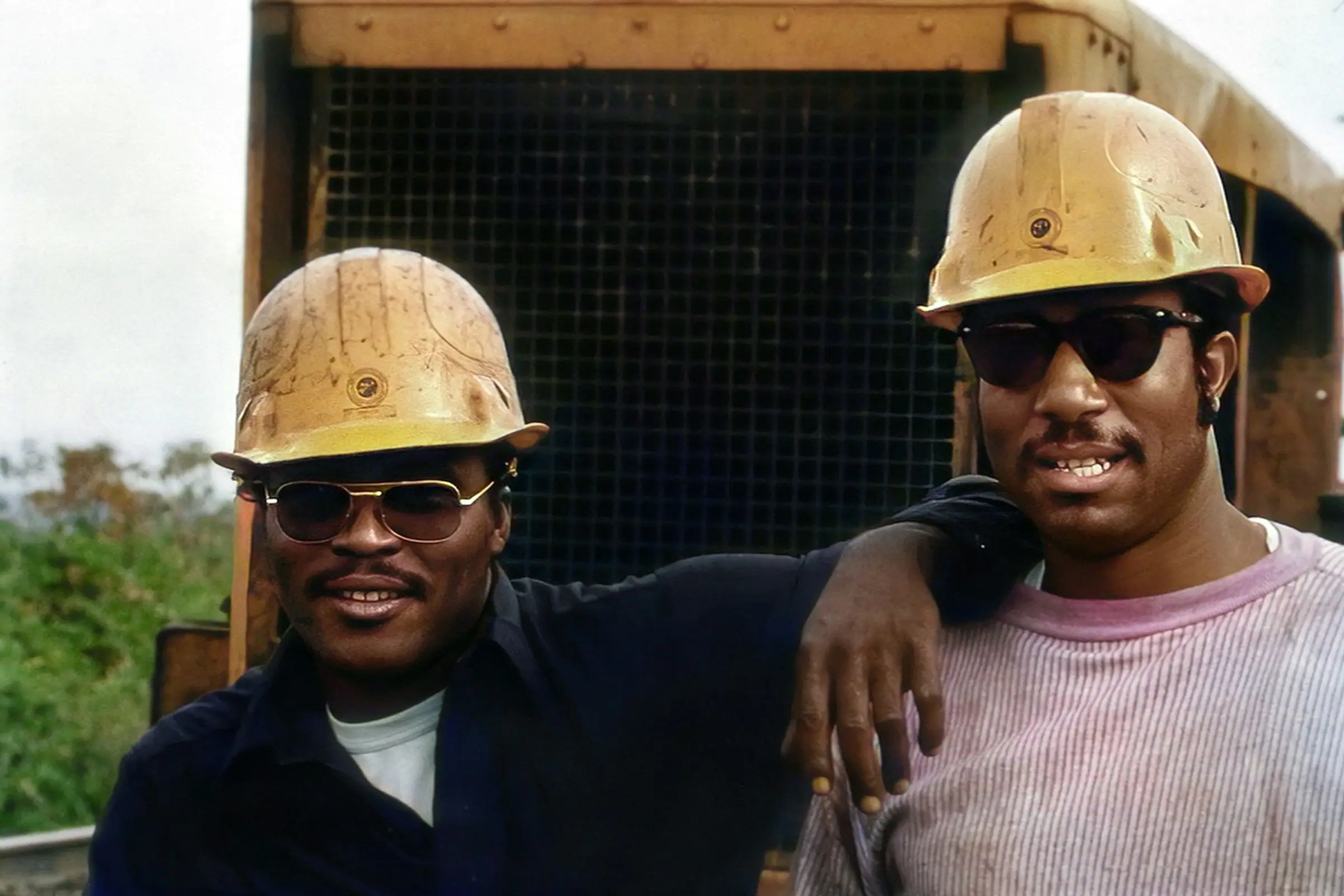 Two engineers in hard hats on site